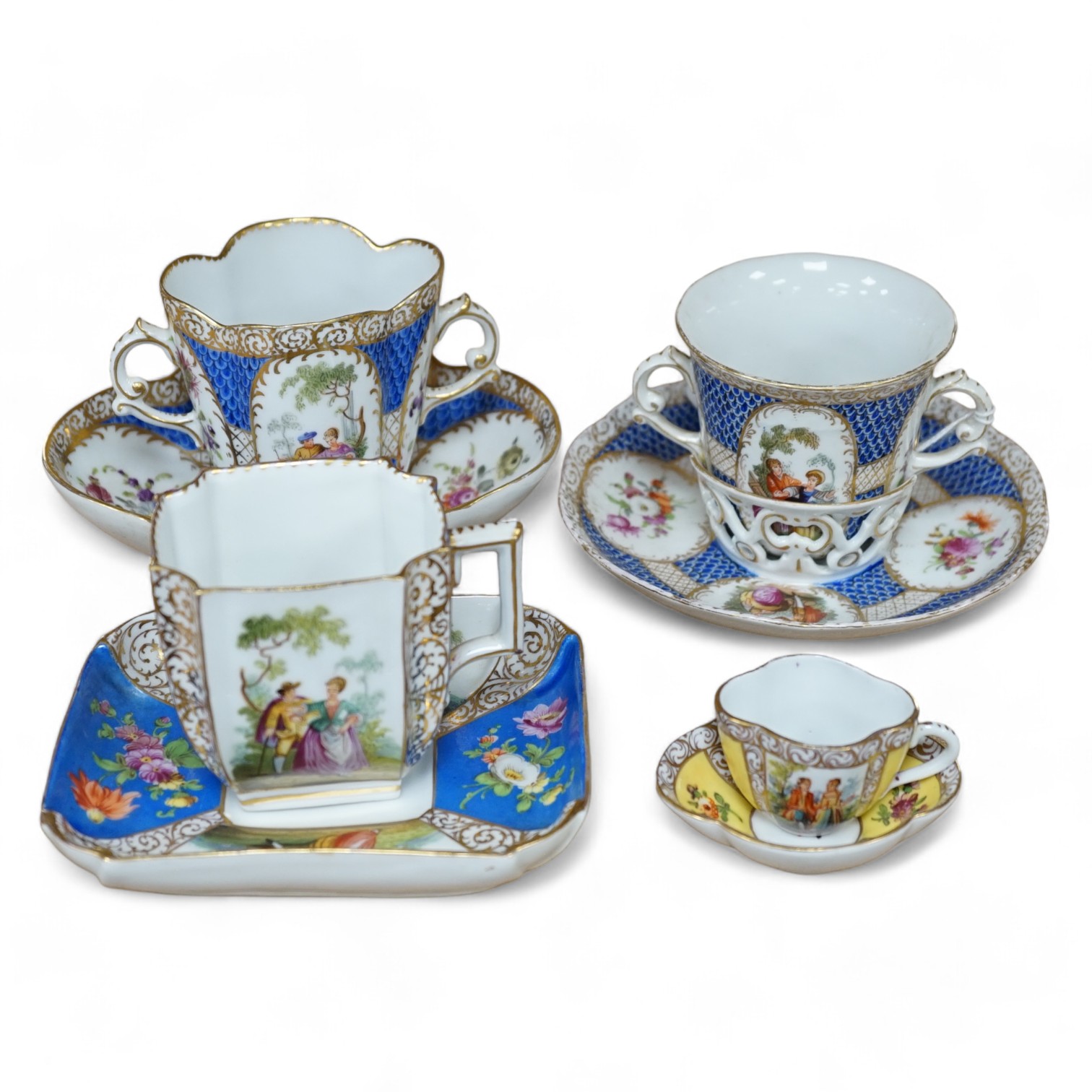 A Crown Dresden porcelain cup and trembleuse saucer, and three other Crown Dresden cups and saucers, largest 14.5cm wide. Condition - good